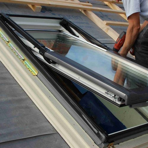 roofer-installing-new-skylight-with-power-tool-2026-03-13-05-01-10-utc