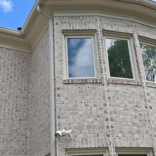 off-white-bow-window-frames-beige-brick-wall Bow Windows in Fairfax, VA
